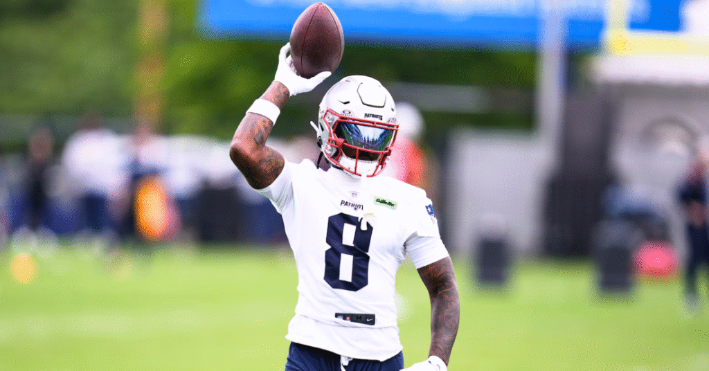 Stefon Diggs catching a football during a Patriots game.